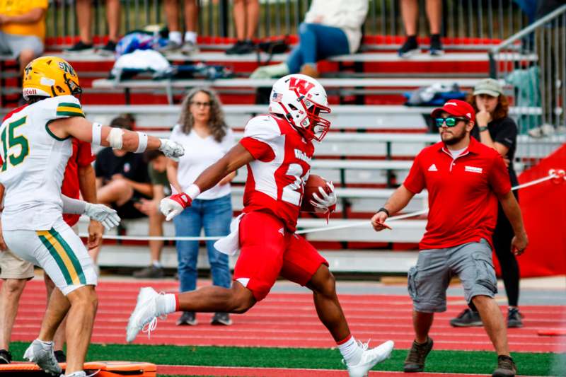 a football player running with a ball