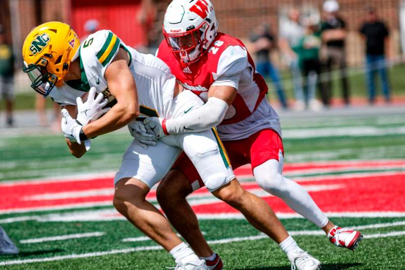 a football player being tackled by another football player