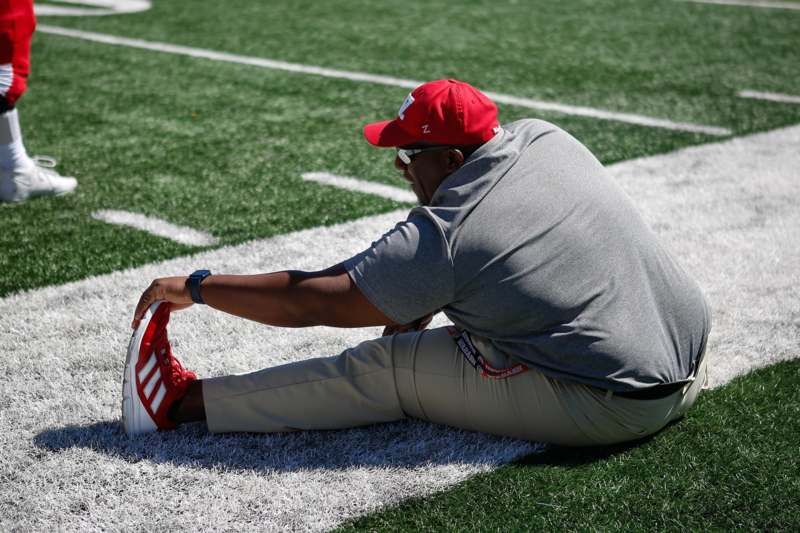 a man stretching on a football field