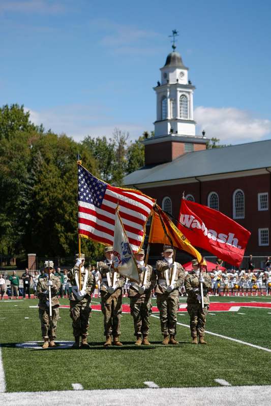 a group of people in uniform holding flags