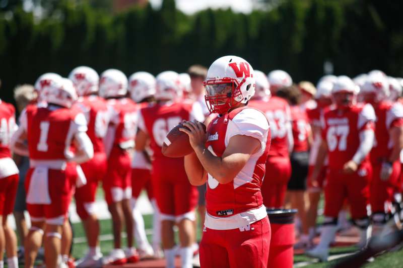 a football player holding a football