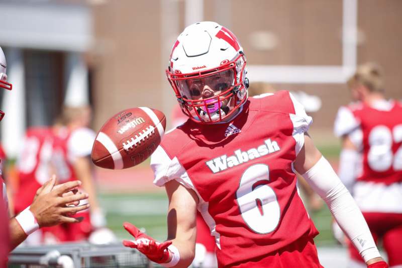 a football player in a red uniform with a football