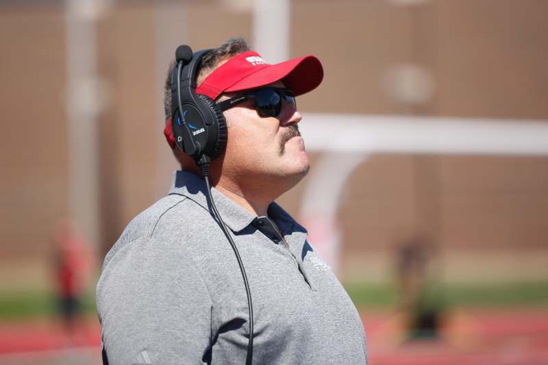 a man wearing headphones and a red hat