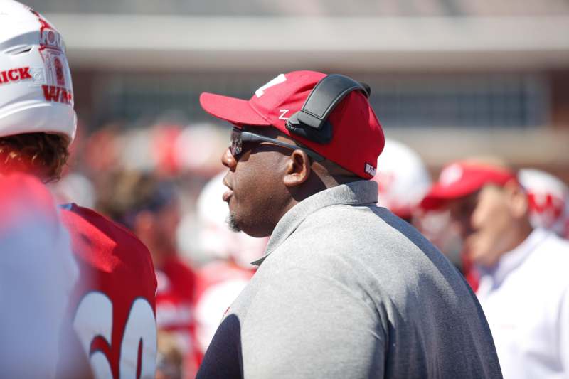 a man wearing a red hat and sunglasses