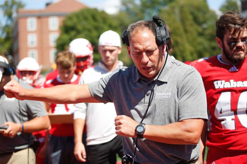 a man wearing headphones and pointing his arm