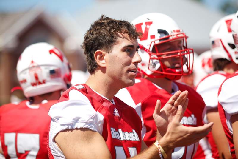 a group of football players clapping