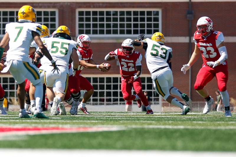 a group of football players running on a field