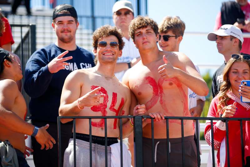 a group of men with red paint on their shirts