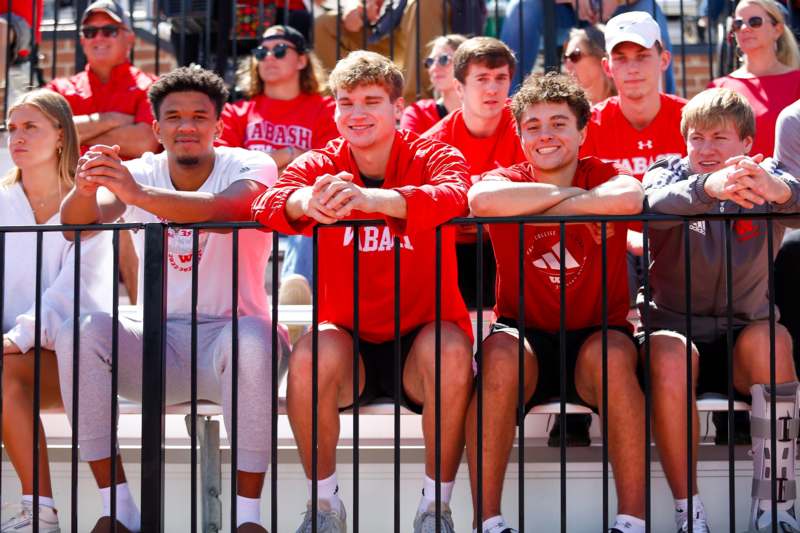 a group of people sitting on bleachers