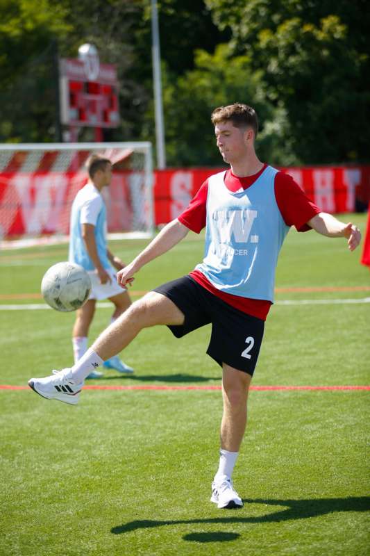 a man kicking a football ball