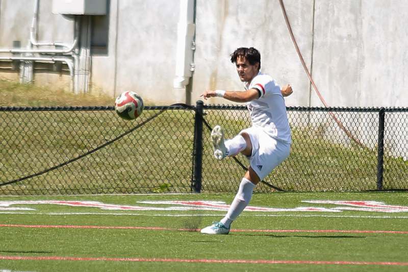 a man kicking a football ball