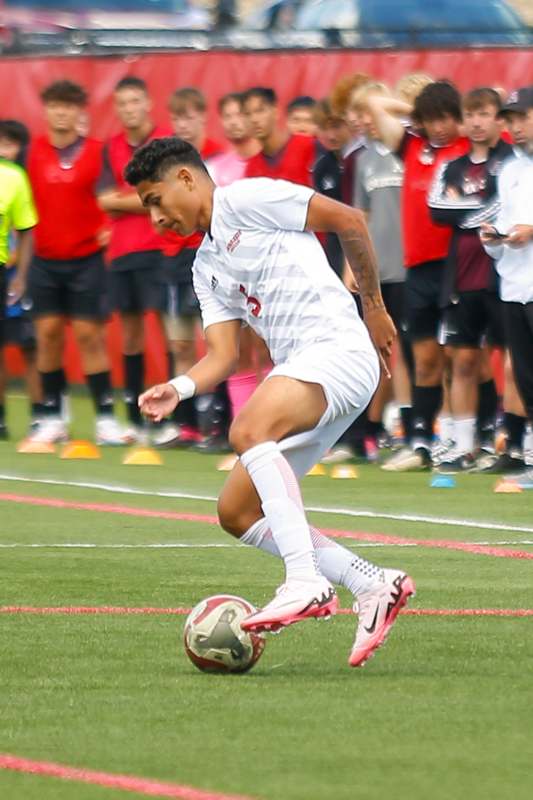 a man kicking a football ball