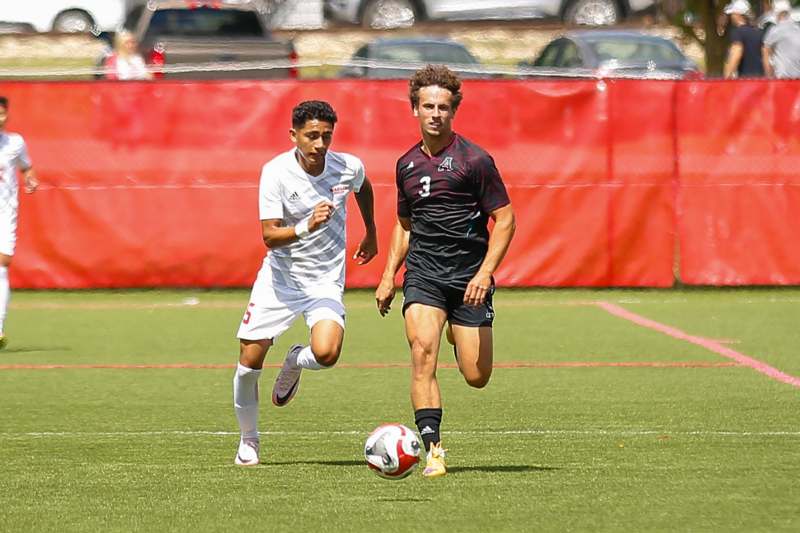 two men playing football on a field