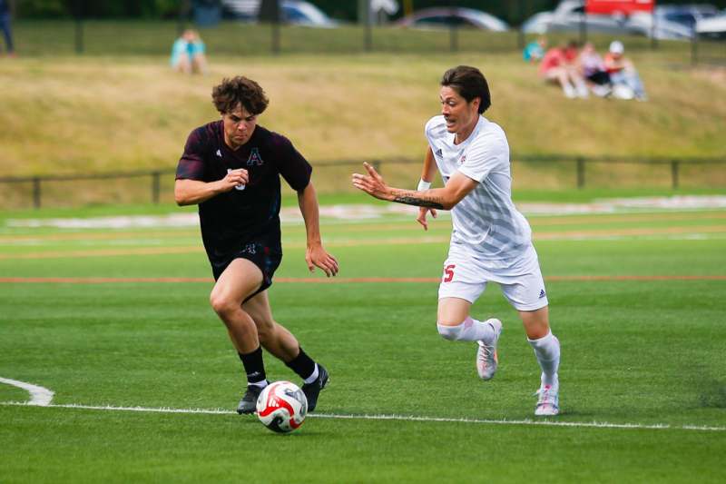 two men playing football on a field