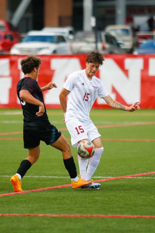 two men playing football on a field