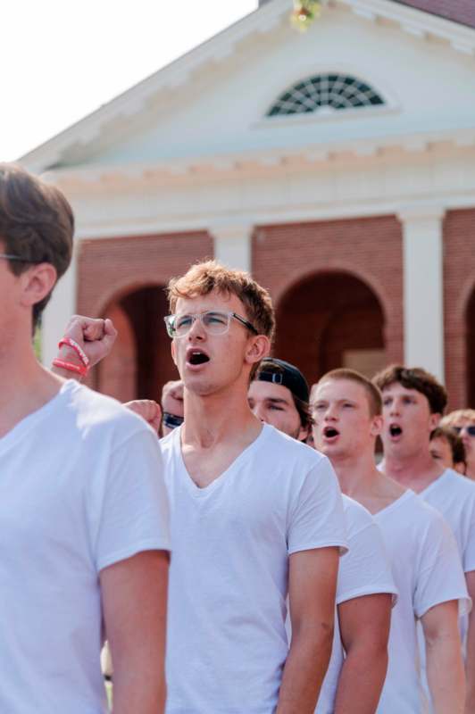 a group of people in white shirts