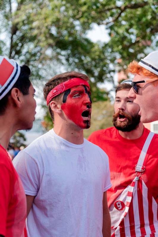 a group of men with red face paint