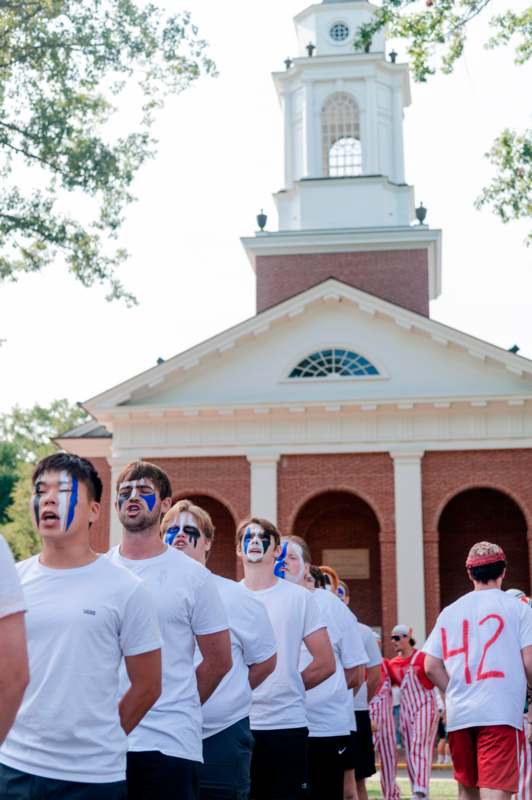 a group of people with face paint outside a building