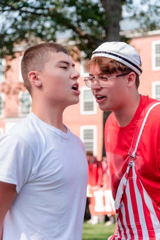 two men standing outside talking