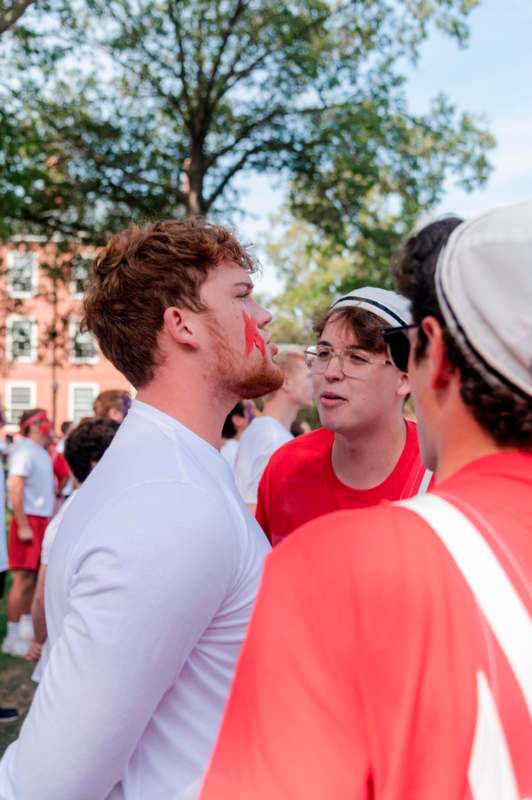 a group of men with red paint on their face