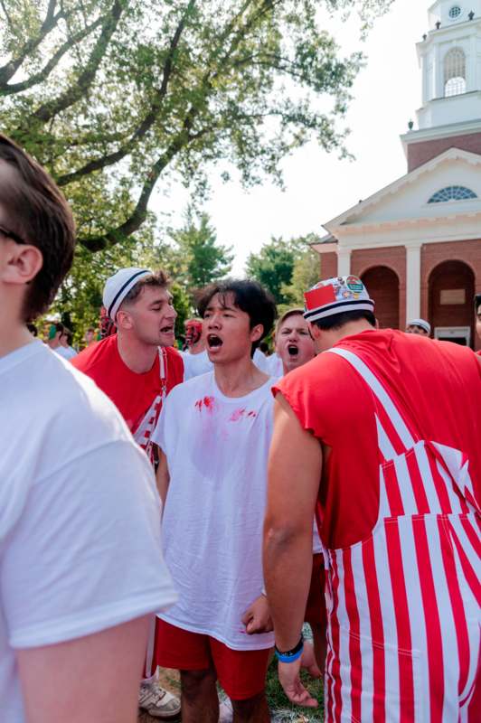 a group of people in red and white shirts