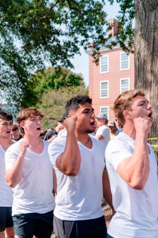 a group of men in white shirts