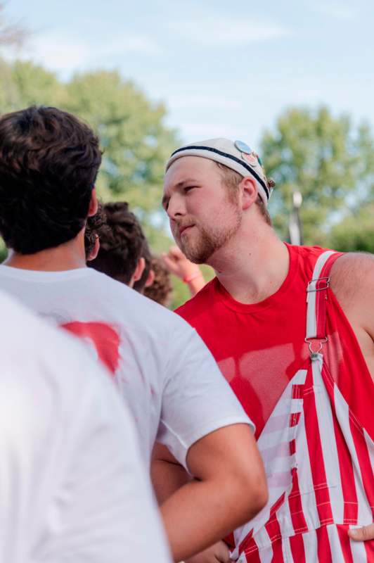 a man in a red tank top and white hat