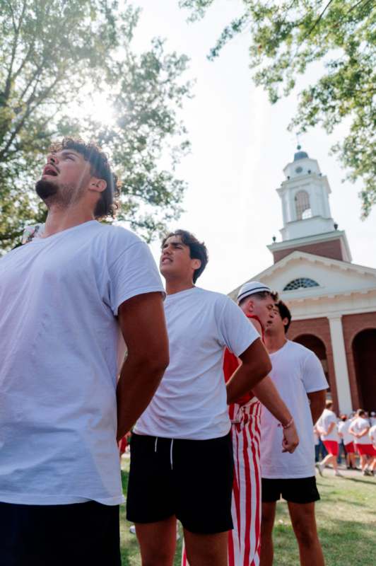 a group of men in white shirts