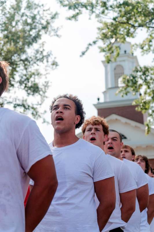 a group of people in white shirts