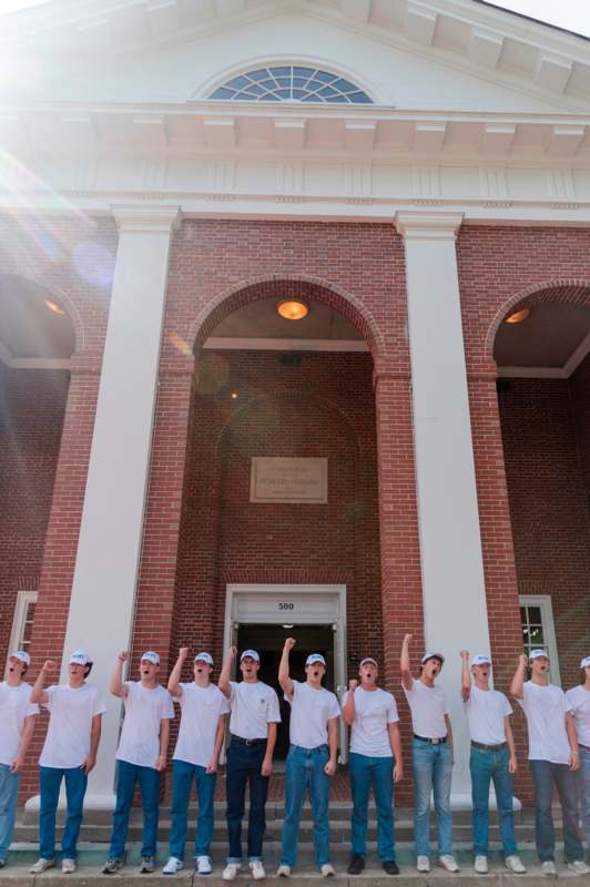 a group of people wearing white shirts