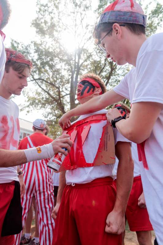 a group of men wearing red and white shirts