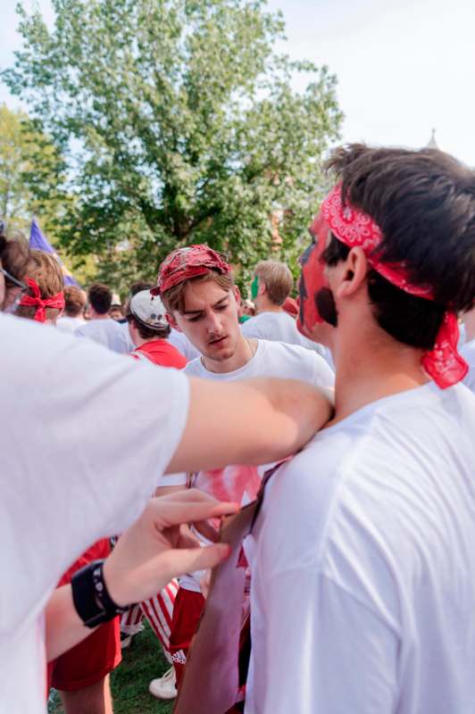 a group of people with red bandana on their head