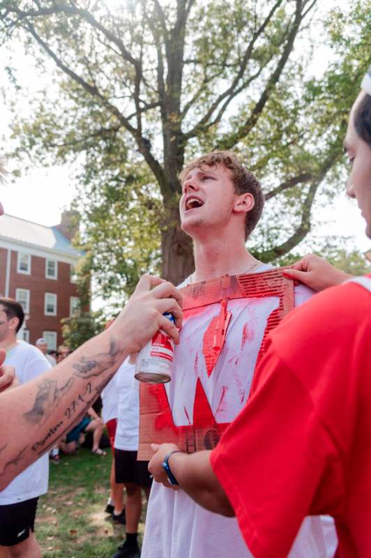 a man holding a spray can and a man's shirt