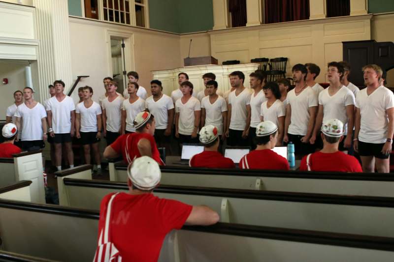 a group of people in white shirts