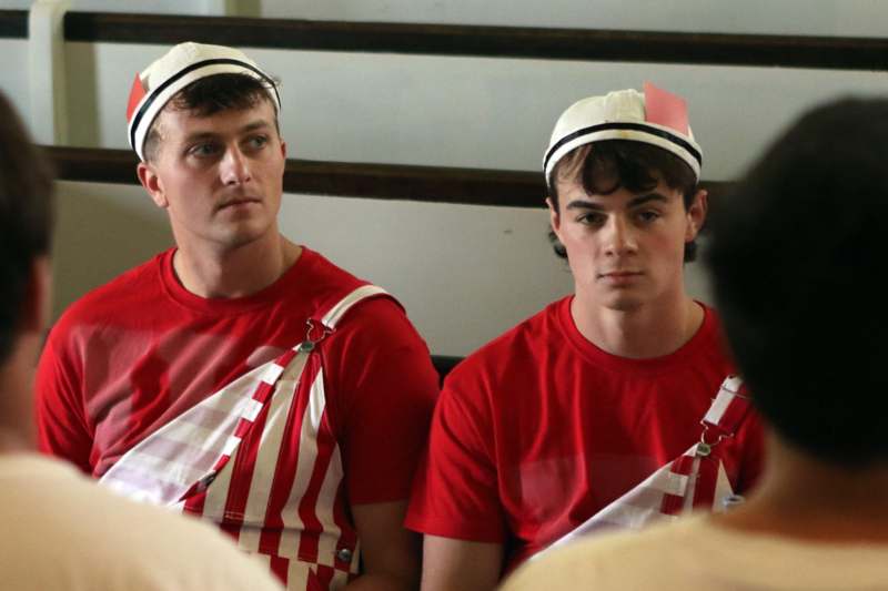 a group of men wearing red and white striped shirts and hats