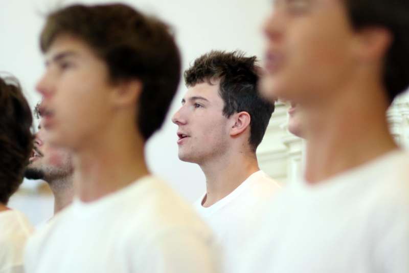 a group of men in white shirts