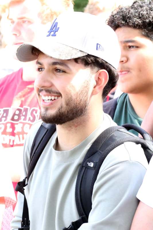 a man wearing a hat and backpack