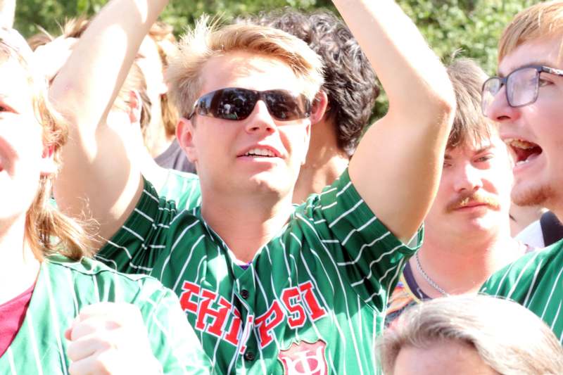 a man in a green jersey with his arms up