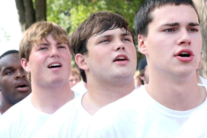 a group of men in white shirts