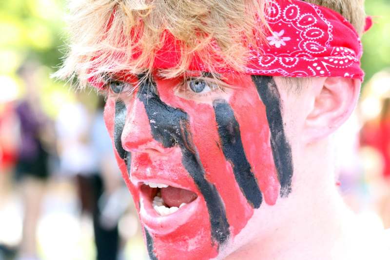 a man with red bandana and black stripes on his face