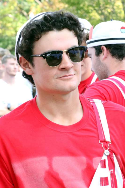 a man wearing sunglasses and a red shirt