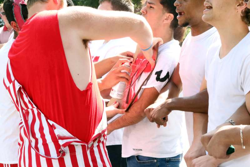 a group of people standing around each other