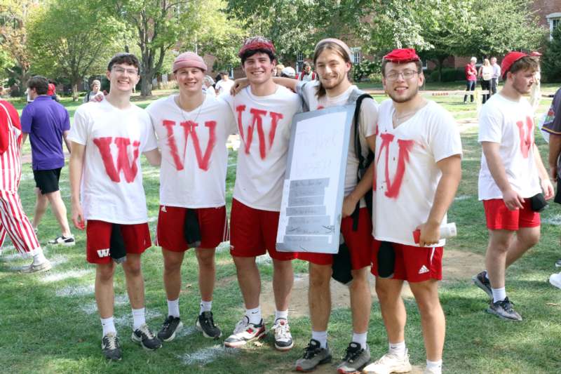 a group of men wearing red and white shirts