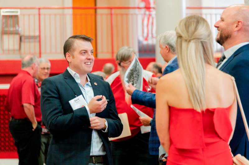 a man in a suit and tie talking to a woman