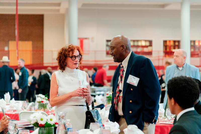 a man and woman talking at a table