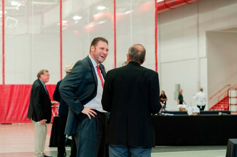 a group of men in suits laughing