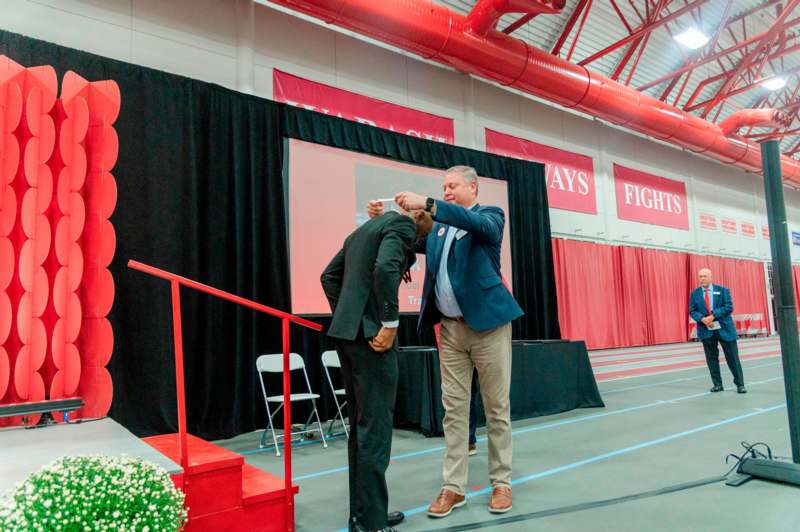 a man touching another man's head