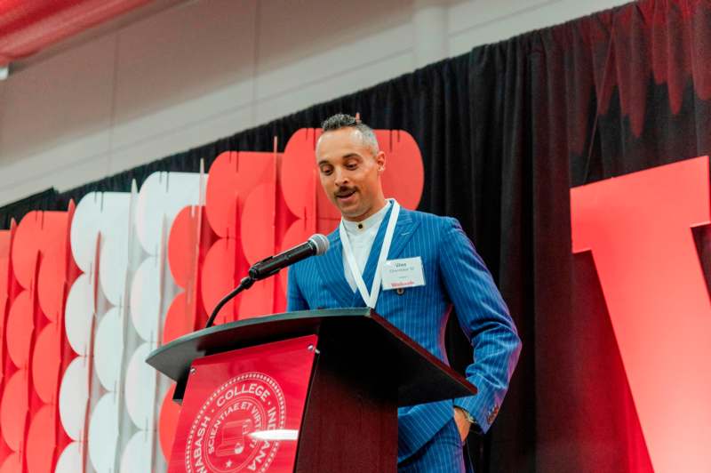 a man standing at a podium with a microphone