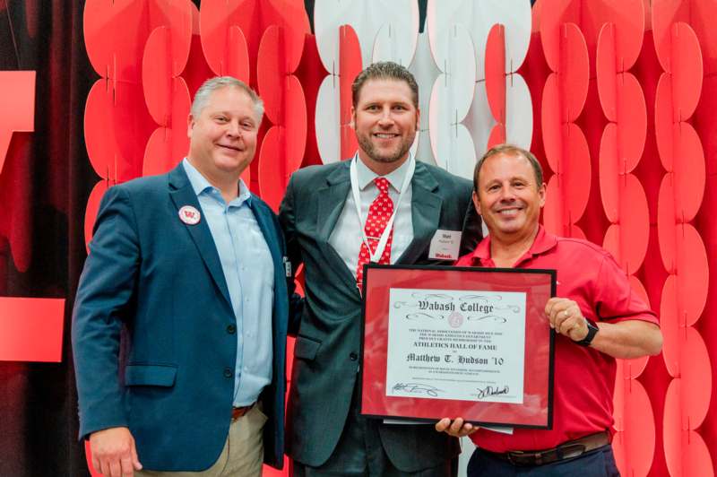 a group of men holding a certificate