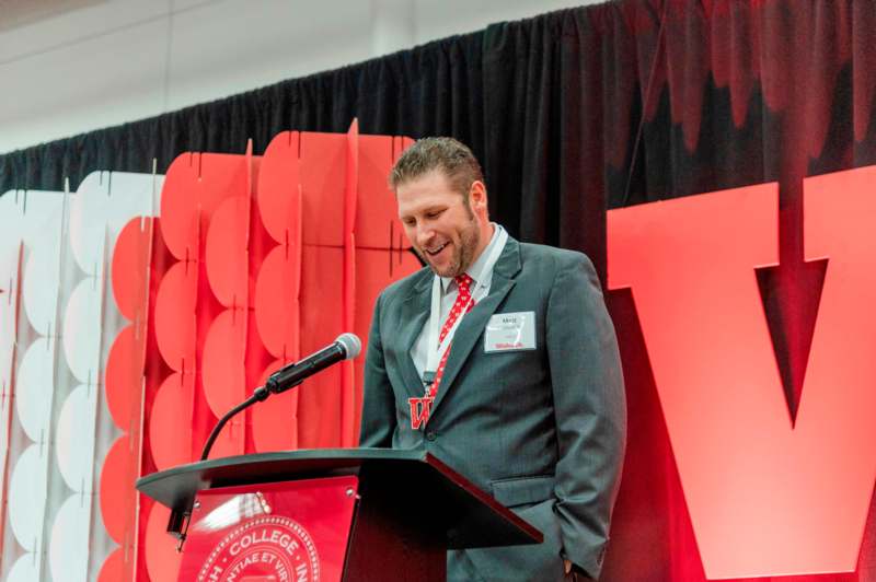 a man standing at a podium with a microphone